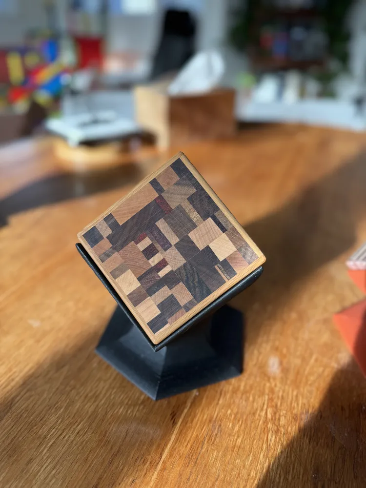 A mosaic coaster set on a black printed stand