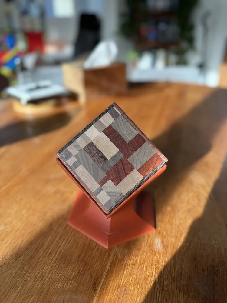 A mosaic coaster set on a terracotta printed stand