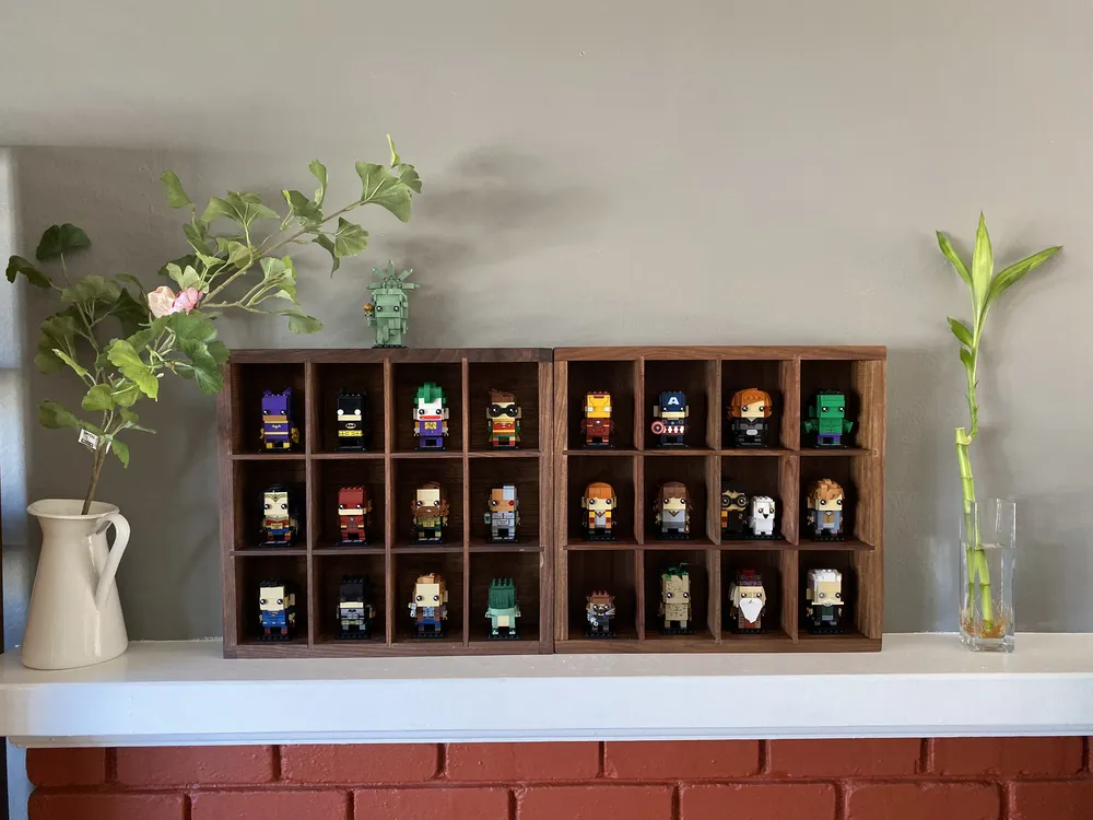 Two filled black walnut shadow boxes on a mantel