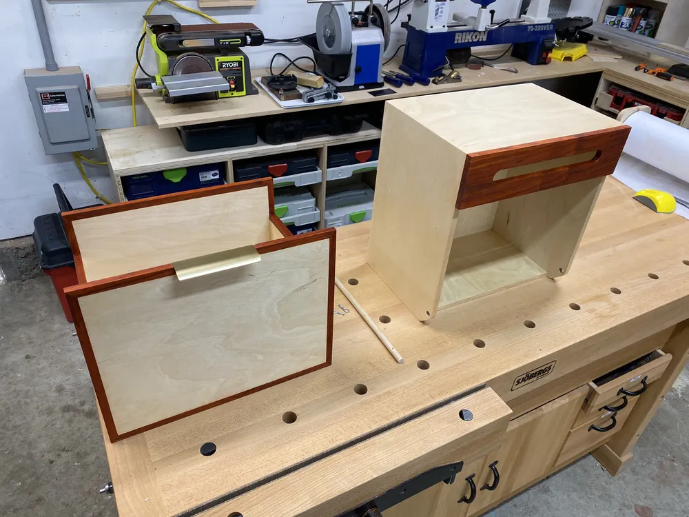 The mailbox and front panel on a workbench before mounting