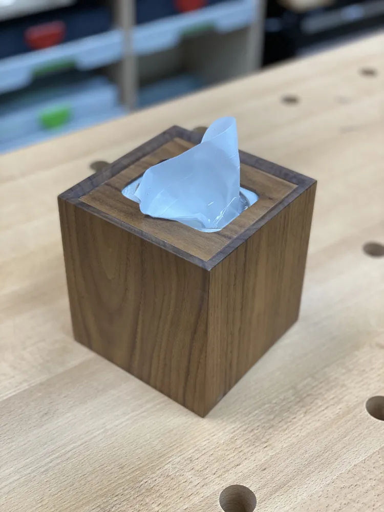 Black walnut cube tissue-box cover on a workbench